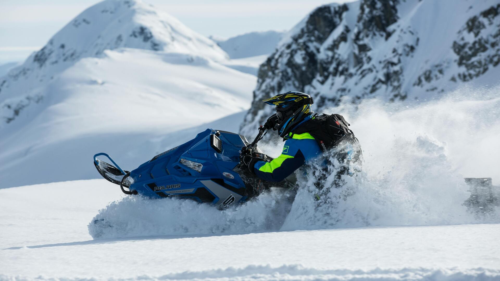 Snowmachine crossing Alaska winter landscape